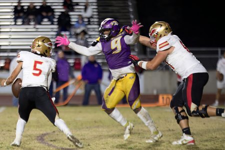 Lemoore's Trevon Gaffney breaks through the line and gets a key sack.